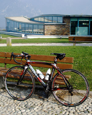 A Pinarello Dogma, the pinnacle of road bike technology, with the Museo del Ciclismo in the background.
