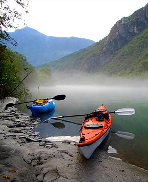 Photo of Kayaks on shore of Lake Como all geared up and ready to go.