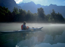 Photo of kayaker on Lake Como with mist on the lake